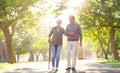 Senior couple, cane and walking outdoor at a park with a love, care and support for health and wellness. A elderly man Royalty Free Stock Photo