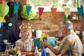 Senior couple celebrating together, elderly birthday woman recieving birthday gift present from her husband sitting at dinner Royalty Free Stock Photo