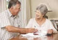 Senior Couple Checking Finances And Going Through Bills Together Royalty Free Stock Photo