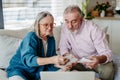 Senior couple checking their bills, concept of family finance. Royalty Free Stock Photo