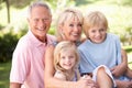 Senior couple with children posing in park