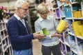 Senior couple are choosing pots at garden center Royalty Free Stock Photo