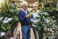 Senior couple are choosing potted plant at garden center Royalty Free Stock Photo