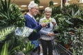 Senior couple are choosing potted plant at garden center Royalty Free Stock Photo