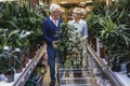 Senior couple are choosing potted plant at garden center Royalty Free Stock Photo