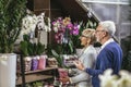 Senior couple are choosing potted plant at garden center Royalty Free Stock Photo