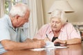 Senior Couple Concerned About Debt Going Through Bills Together Royalty Free Stock Photo