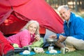 Senior Couple Cooking Breakfast On Camping Holiday Royalty Free Stock Photo