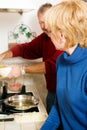 Senior couple cooking dishes in kitchen Royalty Free Stock Photo