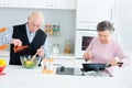 Senior couple cooking food kitchen Royalty Free Stock Photo