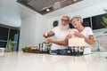 Senior couple cooking healthy meal at home in the kitchen - Elderly and joyful lifestyle - Focus on hands - food nutrition concept Royalty Free Stock Photo