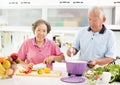 Senior couple cooking in kitchen Royalty Free Stock Photo