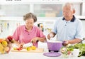 Senior couple cooking in kitchen Royalty Free Stock Photo