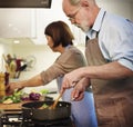 Senior couple cooking together in the kitchen Royalty Free Stock Photo