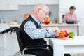 senior couple cooking together - man disabled on wheelchair Royalty Free Stock Photo