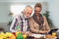 Senior couple counting bills at home Royalty Free Stock Photo