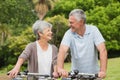 Senior couple on cycle ride at park Royalty Free Stock Photo