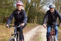 Senior Couple On Cycle Ride In Winter Countryside