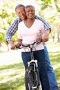 Senior couple cycling in park Royalty Free Stock Photo