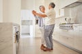 Senior couple dance, kitchen and elderly love of people spending quality time together at home. Happy retirement of a Royalty Free Stock Photo