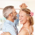 Senior couple, dancing and happy in home, romantic and ballroom for fun, touch and love. Retirement, bonding together