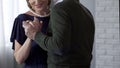 Senior couple dancing, man tenderly holding woman hand, special occasion Royalty Free Stock Photo