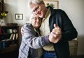 Senior couple dancing together at home