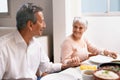 Senior couple, dinner and holding hands in home dinning room, praying and gratitude for meal. Grace, smile and love at Royalty Free Stock Photo