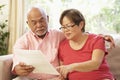 Senior Couple Discussing Document At Home