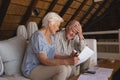 Senior couple discussing over medical bills in living room Royalty Free Stock Photo