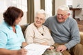 Senior Couple In Discussion With Health Visitor Royalty Free Stock Photo