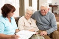 Senior Couple In Discussion With Health Visitor Royalty Free Stock Photo