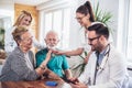 Senior Couple In Discussion With Health Visitor At Home. Royalty Free Stock Photo