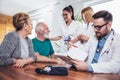 Senior Couple In Discussion With Health Visitor At Home. Royalty Free Stock Photo