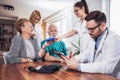 Senior Couple In Discussion With Health Visitor At Home. Royalty Free Stock Photo