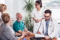 Senior Couple In Discussion With Health Visitor At Home. Royalty Free Stock Photo