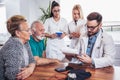 Senior Couple In Discussion With Health Visitor At Home. Royalty Free Stock Photo