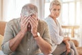 Senior couple, divorce and conflict in fight, argument or disagreement on living room sofa at home. Elderly woman and