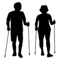 Senior couple do nordic walking in the park silhouette.