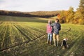 Senior couple with dog on a walk in an autumn nature. Royalty Free Stock Photo