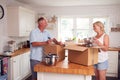 Senior Couple Downsizing In Retirement Packing And Labelling Boxes Ready For Move Into New Home Royalty Free Stock Photo