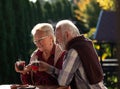 Senior couple drinking coffee in garden Royalty Free Stock Photo