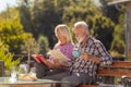 Senior couple drinking coffee outdoor and reading Royalty Free Stock Photo