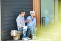 Senior Couple Drinking Tea in Front Yard Royalty Free Stock Photo