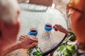 Senior couple drinking tea in hotel cafe holding hands. People enjoying vacation. Close-up Royalty Free Stock Photo