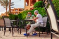 Senior couple drinking tea in hotel cafe. People enjoying vacation. Valentine`s day Royalty Free Stock Photo