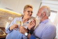 Senior couple drinking wine in kitchen Royalty Free Stock Photo