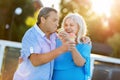 Senior couple eating ice cream, laughing.