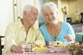Senior Couple Eating Meal Together In Kitchen Royalty Free Stock Photo