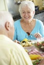 Senior Couple Eating Meal Together In Kitchen Royalty Free Stock Photo